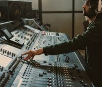 Side View Of Concentrated Sound Producer Working At Studio